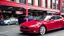 Placeholder: A Tesla's 'Model S Plaid' is parked, at the 'Pike Place Market', in Seattle. CINEMATIC. WIDE ANGLE LENS. PHOTO REAL.