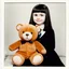 Placeholder: White haired wednesday addams as a child, with an ugly teddy bear, polaroid, 1970s