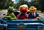 Placeholder: World Class Photograph of 3 Sesame Street muppets sitting in a convertible car on a road trip - one is Kermit the Frog, one is Cookie Monster, and one Looks exactly like Donald Trump