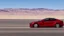 Placeholder: A Tesla's 'Model S Plaid' is racing at top speed, by the 'Lake Mead', in Nevada. CINEMATIC. WIDE ANGLE LENS.