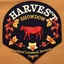 Placeholder: an autumn colored textured cloth embroidered ornamental leaves and cattle, pointed bottom, on dark background, embroidered text across top "HARVEST SHOWDOWN" block text, below is more embroidered text "Heartland Livestock Services Futurity Heifer Show", Canadian western cowboy style