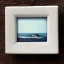 Placeholder: tiny oil painting of tiny seaside village, plain white background, solid white background, tiny white canvas, tiny white frame, melancholy, tender, moody, vintage, delicate arrangement, beautiful composition, etsy, aesthetic layout, plain solid white background