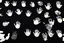 Placeholder: multiple white hand prints on a solid black background. some hand prints have finger streaks