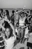 Placeholder: party on the beach of Porto Racanti in the middle of summer, music, dancing, celebration, toast, photography taken with a Leica camera and a 35 mm lens, black and white photography