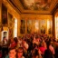 Placeholder: Party in a schloss, cheering people, Austrian aesthetic, warm colors, wooden floor, green walls, red, chiaroscuro, 8k, HD, cinematography, photorealistic, Cinematic, Color Grading, Ultra-Wide Angle, Depth of Field, hyper-detailed, beautifully color-coded, insane details, intricate details, beautifully color graded, Cinematic, Color Grading, Editorial Photography, Depth of Field, DOF, Tilt Blur, White Balance, 32k, Super-Resolution, Megapixel, ProPhoto RGB, VR, Halfrear Lighting, Backlight