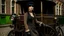 Placeholder: body portrait of a gothic woman with a black bob with a full fringe hairstyle, dressed in brown leather trousers, waistcoat, and gloves, in a Victorian street next to a steam carriage, full colour