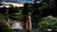 Placeholder: country side small river nice rocks at floor wild flowers blosom pretty sky and cloudes a beautiful young girl standing gracefully in water