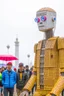 Placeholder: little people looking at dancin to giant robotvitalik buterin at burning man festival in the rain