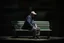 Placeholder: man sitting on a bench in the street