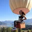 Placeholder: very beautiful lady with beautiful sports pant and top and sports shoes with curvy hair in a nice balloon ridding in sky of a nice villa yard with trees flowers ,in country side in floor of beautiful mountains ,sea with ships ,water falls ,