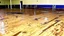 Placeholder: lady dirties wood floor in public fitness gym