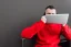 Placeholder: Man using laptop in red sweater