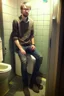 Placeholder: Tall and skinny game designer spends his day on the toilet