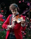 Placeholder: Gorgeous Realistic Photography a handsome young man a stunning adorned in vibrant luxury casual man clothing carnival attire, headphones,playing violin standing in garden park flowers,ethereal beauty, black background, with swirling colors and fantastical tiny flowers, enchantment and grace, twisted vines, whimsical, surreal landscapes, emotive style, dreamlike quality, and magical realism, carnival red, ethereal pink, whimsical blue, vibrant green, celestial purple, golden amber