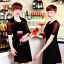 Placeholder: Russian guy young wife boyish boylike short man's haircut men's face boyish features in black girlish lacy cocktail dress as mother in restaurant