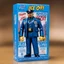 Placeholder: A photograph of a pristine action figure encased in its packaging, evoking a sense of collectible wonder, styled after a vintage toy advertisement. The box prominently displays "Ice-T" in bold, stylized lettering, with the action figure inside clearly resembling Ice-T as NYPD detective/sergeant Odafin Tutuola, possessing his iconic features confidently with a badge