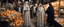 Placeholder: A full-length Palestinian girl wearing an embroidered dress and a white embroidered shawl buys oranges from an old seller wearing a keffiyeh in the market of Jerusalem, 100 years ago, at night with multi-colored lights reflecting on her.