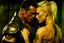 Placeholder: Jason David Frank as very muscular man with short hair and tribal tattoos piercings embracing pretty blond girl realistic dark fantasy