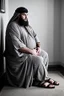 Placeholder: close up photography of a Burly arab 26 year old stocky short chubby man on his knees, short beard, dressed in an brown economic traditional caftan with pants and sandals, photorealistic, ambient occlusion, in a simple living room, ambient occlusion, side view from the bottom