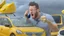 Placeholder: guy in hurricane arguing on phone next to his kia sportage made out of lemons