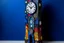Placeholder: A dark blue clock tower in a galaxy designed in Mexican folk art painted by Wassily Kandinsky
