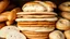 Placeholder: Layers filled with fancy breads including baguettes, sandwiches, dough, bagels, tortillas, white, and whole wheat and wheat ears and sesame seeds and freshly baked sliced ​​breads and a classic theme.