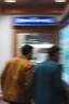 Placeholder: two men walking away. blurry
