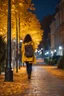 Placeholder: night yellow lights over the street trees autumn leaves under feet ,a Student adult girl with books in her bag walking in street back to camera