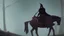 Placeholder: Dark robed wizard on a horse in the forest