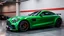 Placeholder: Mercedes-Benz AMG GT63s, green, with four side doors parked in a luxury garage, with the car facing right