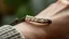 Placeholder: macro photo of a bracelet made of brown leather and tiny pearls on a woman's wrist, detailed, sharp contrasts, realistic, cinematic, blur background