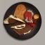 Placeholder: Plate full of fake food with old stuff around in a dark room