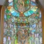 Placeholder: A big Art Nouveau stained-glass window in an Art Nouveau villa by artist "Alphonse Mucha"