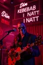 Placeholder: An spanish Guy with stalker big eyes "Enrique" performing at dance club, his name is the stalker "Enrique" Red roses On stage, red Neon lights and smog, and "Din KEBAB I NATT" big sign on the wall, serenade under balcony, ZORRO vibes