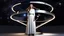 Placeholder: picture of a very huge real working physic based gyroscope with mirror surfaces in a inter star environment ,a very pretty lady with modern future clothing boots standing in main turning disk of gyroscope.1x1