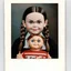 Placeholder: wednesday addams as a child, braids, with a chucky doll, worn polaroid, 1970s