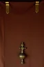 Placeholder: darker textured hanging fabric background, with decorative brass corners at top, and a heavy brass decorative element attach across the bottom