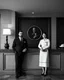 Placeholder: american gothic as hotel staff behind reception counter