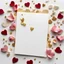 Placeholder: A photo of a white card, 5.5 by 4.25 inches. The card is vertically positioned on a beautiful white surface, positioned between rose petals and litte golden hearts.