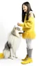 Placeholder: Giant white dog in a feather dress, next to a girl in a yellow sweater, a gray skirt, white stockings and black shoes, both facing the front in the photo. white background, 16K, real photography, portrait.