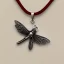 Placeholder: necklace with a simple, elegant design featuring a single, shimmering polyester in dragonfly pendant