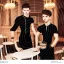 Placeholder: Russian guy student boy boyish boylike short man's haircut men's face boyish features female figure in black girlish lacy cocktail dress earrings in restaurant