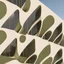 Placeholder: The facades of a building inspired by the olive kernel, presented in a minimalist and modern style.