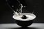 Placeholder: a highly detailed cinematic photograph of a small black ball falling down in a bowl of milk
