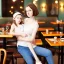 Placeholder: Realistic photo Russian shorthair beautiful 20-years tomboy boyish boylike young wife wide hips in restaurant with little daughter