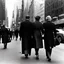 Placeholder: People in 1950 walking on a street in New York, black and white