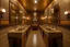 Placeholder: Pictures of a group of bathrooms in Mathaf Restaurant. The walls and floors are in brown tones, and the sinks are on one wall.