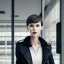 Placeholder: A tall slender young woman with short hair and a black trench coat longingly waiting for her lover at an airport