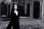 Placeholder: the seducing Morticia Addams in her manor