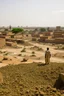 Placeholder: Sudan, destroyed city, airstrikes, one man in the distance